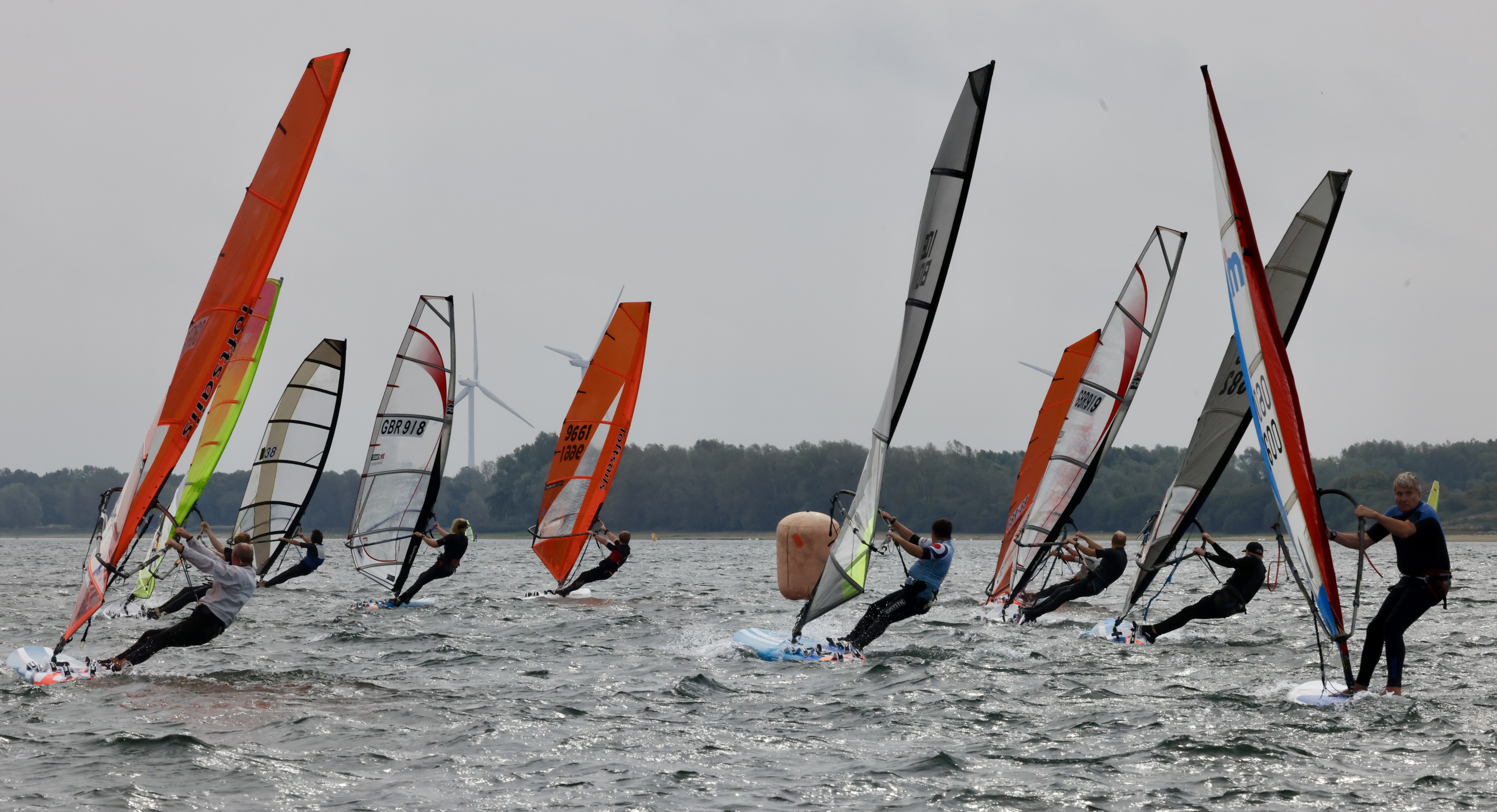 Windsurfers on the water. [Caption: Windsurfers on the water],